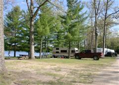 View of Trees and Lake with Camper and Truck